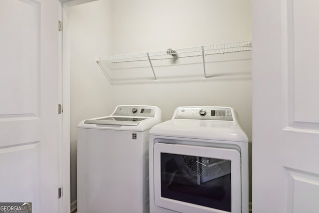 washroom with washer and clothes dryer