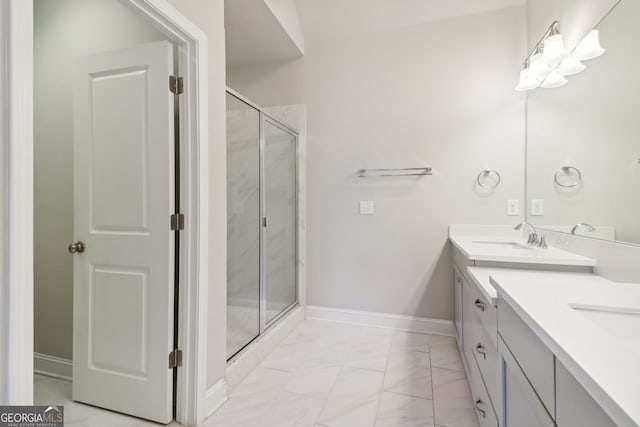 bathroom featuring a shower with door and vanity