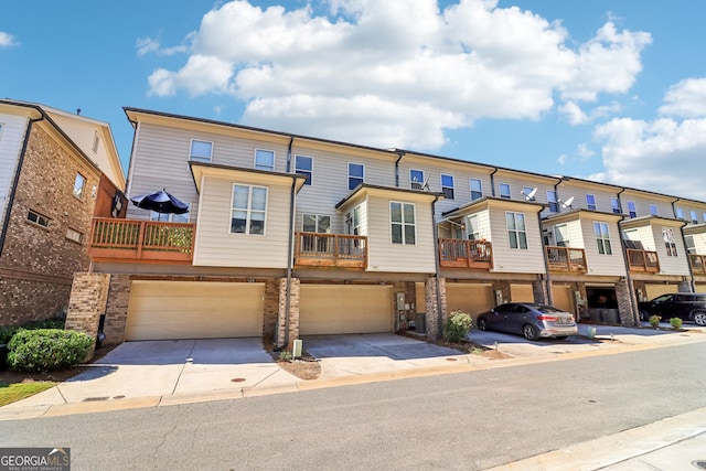 multi unit property featuring a balcony and a garage