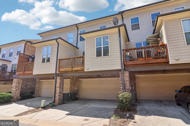 back of house featuring a garage and a balcony