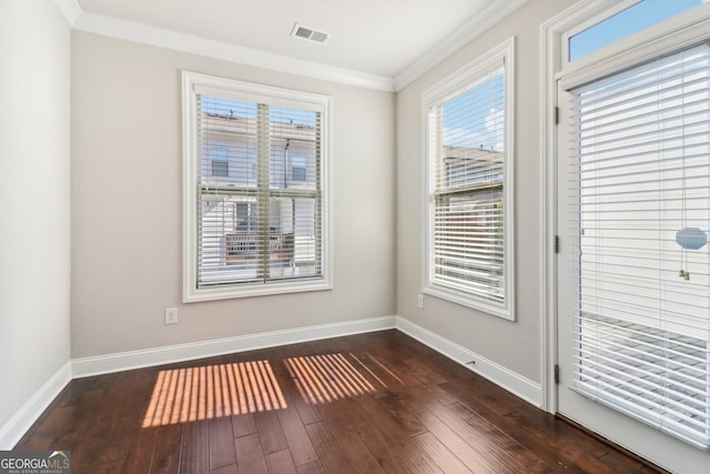 spare room with crown molding and dark hardwood / wood-style floors