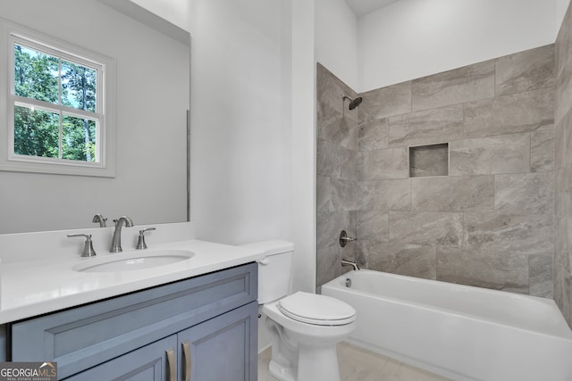 full bathroom with vanity, toilet, and tiled shower / bath