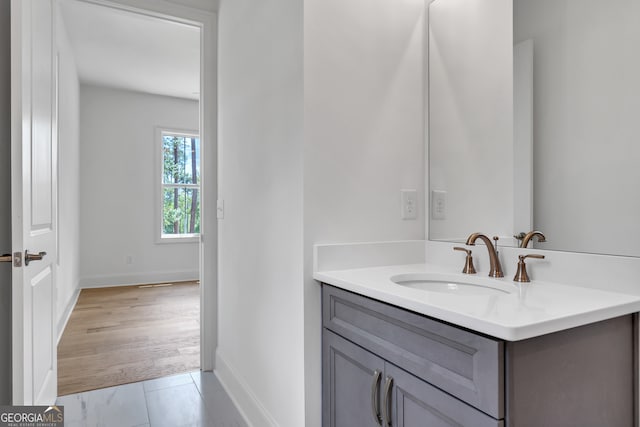 bathroom with vanity and hardwood / wood-style floors