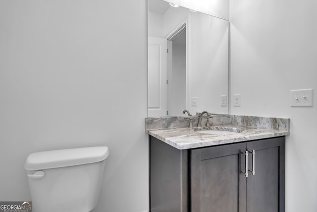 bathroom with toilet and vanity