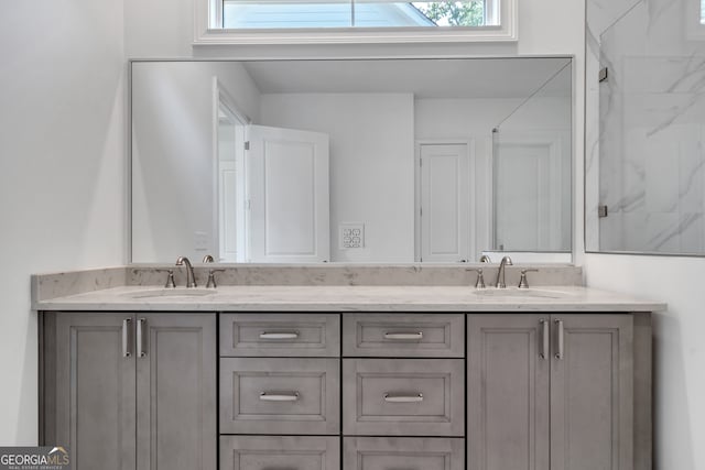 bathroom with vanity, a shower, and plenty of natural light