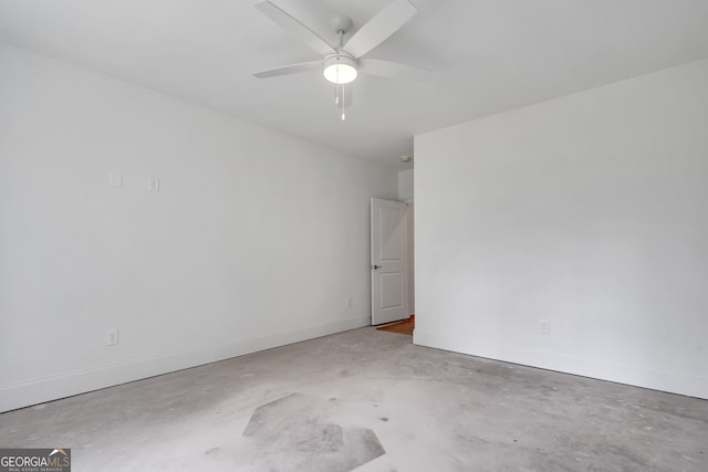 spare room featuring concrete floors and ceiling fan