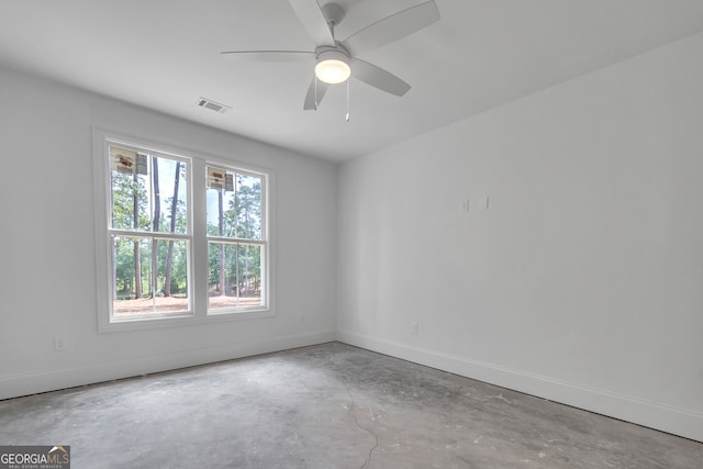 spare room with concrete flooring and ceiling fan