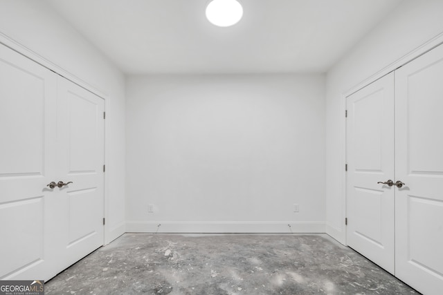 unfurnished bedroom featuring concrete floors