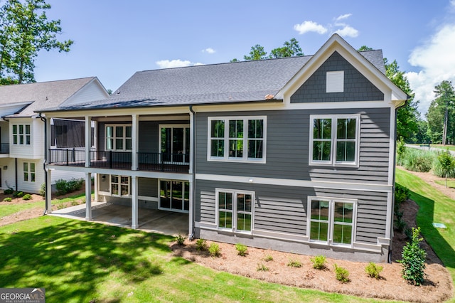 back of property featuring a patio and a lawn