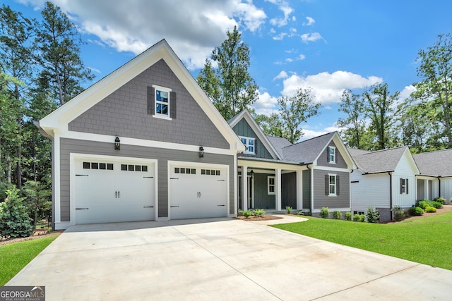 craftsman house featuring a front yard and a garage