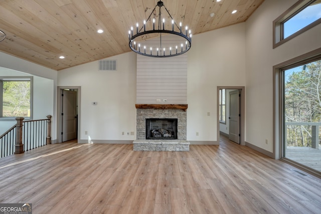 unfurnished living room featuring high vaulted ceiling, a healthy amount of sunlight, wooden ceiling, and light hardwood / wood-style flooring