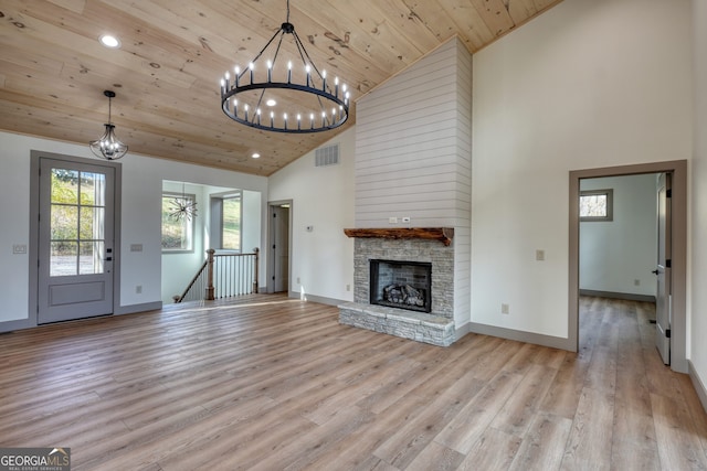 unfurnished living room with light hardwood / wood-style floors, wood ceiling, high vaulted ceiling, and a fireplace