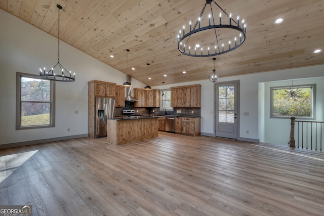 kitchen with appliances with stainless steel finishes, hanging light fixtures, light hardwood / wood-style floors, and wooden ceiling