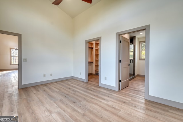 spare room featuring a healthy amount of sunlight, light wood-type flooring, and ceiling fan