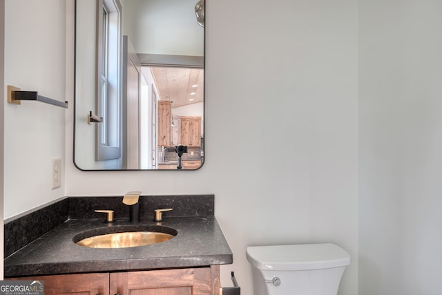 bathroom featuring vanity and toilet