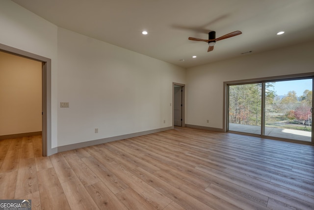 spare room with ceiling fan and light wood-type flooring