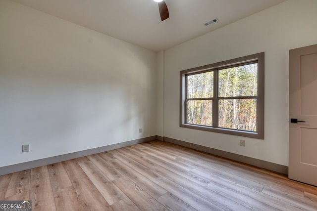 spare room featuring light hardwood / wood-style flooring and ceiling fan