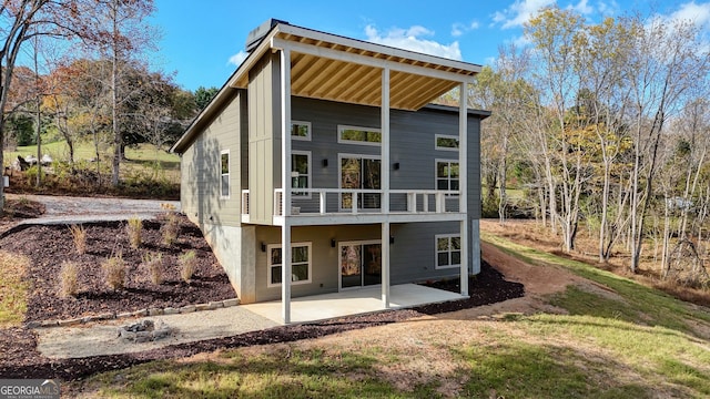 back of house with a patio and a balcony