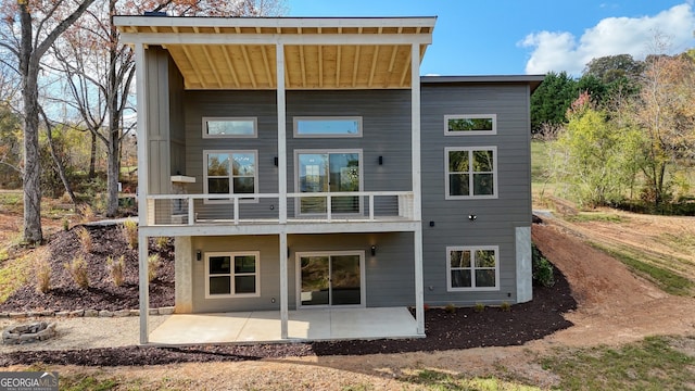 back of property with a patio and a balcony