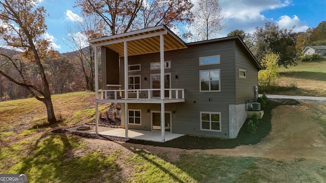 back of house with a patio and a yard