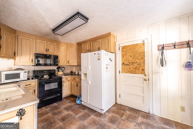 kitchen with light brown cabinetry, black appliances, and a textured ceiling