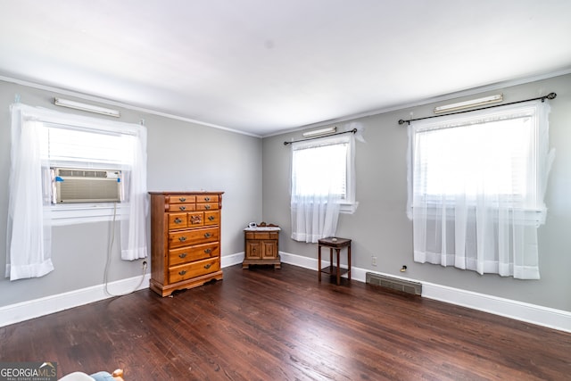 interior space with cooling unit, ornamental molding, and dark hardwood / wood-style flooring