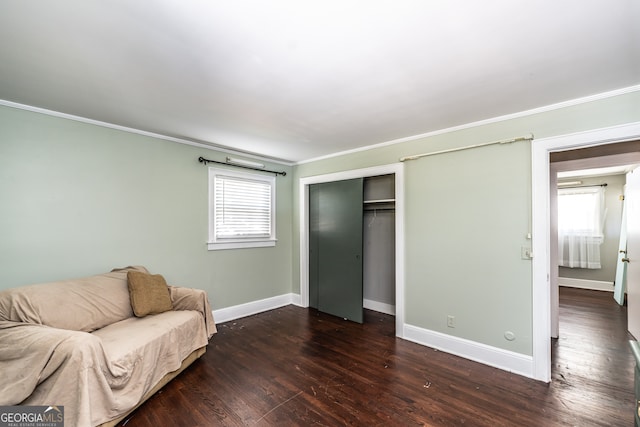 unfurnished room with a wealth of natural light, crown molding, and dark hardwood / wood-style flooring