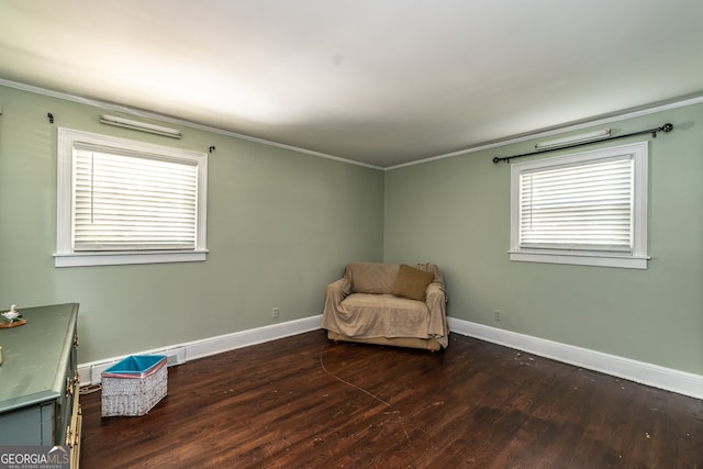 sitting room with ornamental molding, a wealth of natural light, and dark hardwood / wood-style flooring