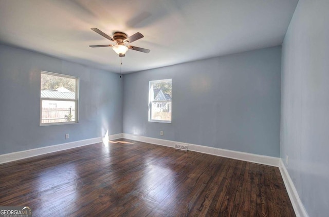 spare room featuring ceiling fan and dark hardwood / wood-style flooring