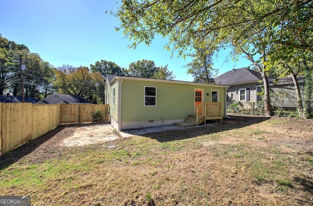 rear view of property with a lawn