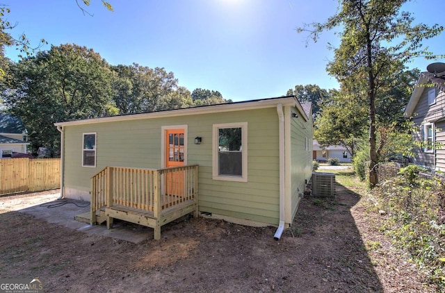 rear view of house featuring central AC