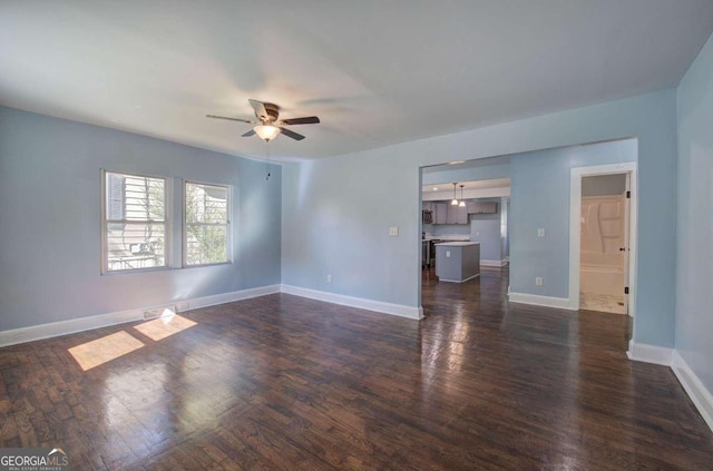 empty room with dark hardwood / wood-style floors and ceiling fan