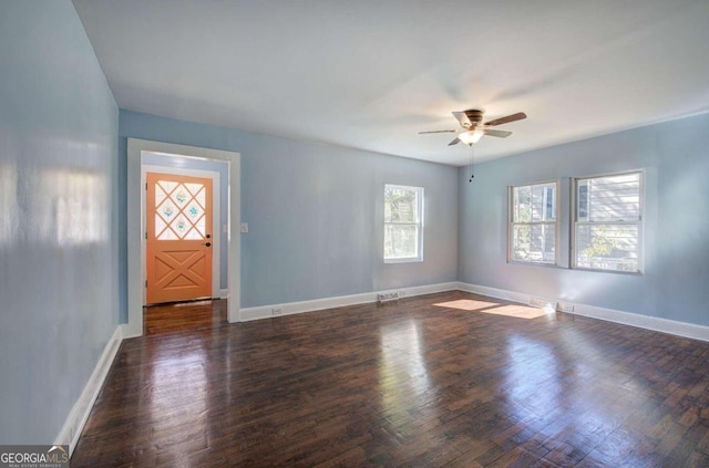 unfurnished room with dark wood-type flooring and ceiling fan