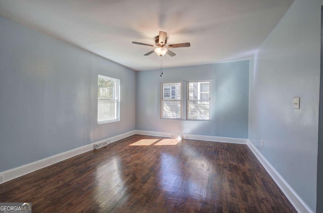 unfurnished room with ceiling fan and dark hardwood / wood-style floors