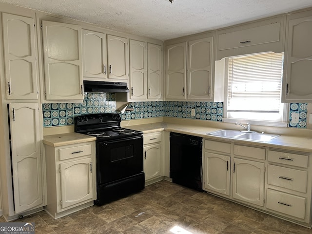 kitchen featuring tasteful backsplash, black appliances, sink, cream cabinetry, and a textured ceiling