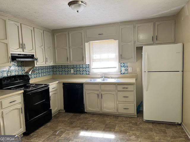 kitchen with black appliances, sink, and cream cabinetry