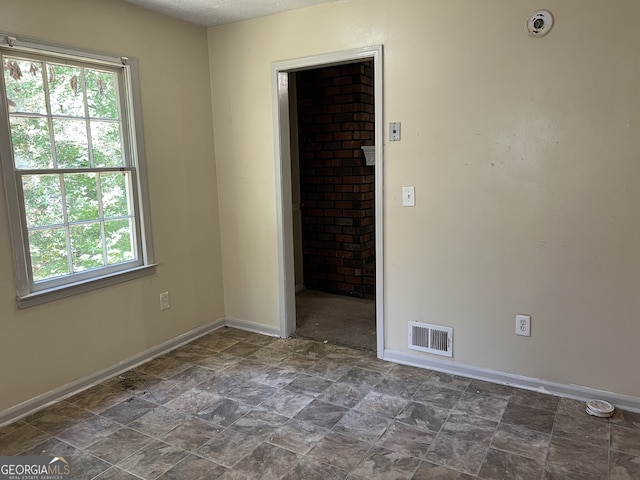 empty room featuring a textured ceiling