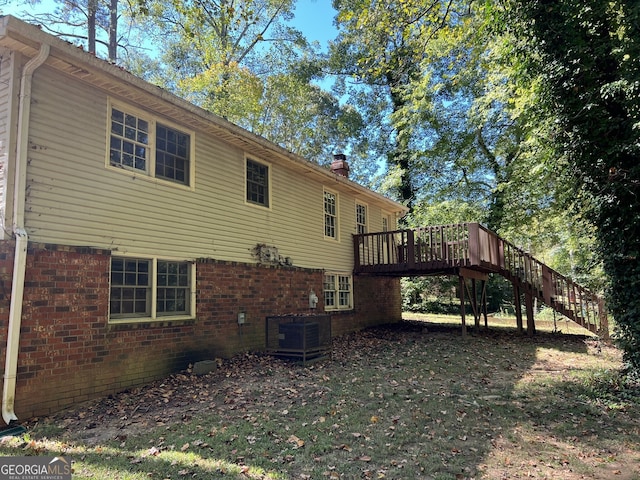 view of home's exterior with a wooden deck and cooling unit