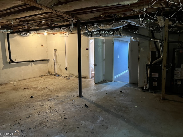 basement featuring water heater and heating unit