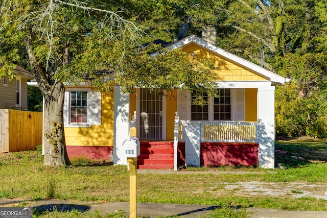 view of front of home with a front lawn and a porch