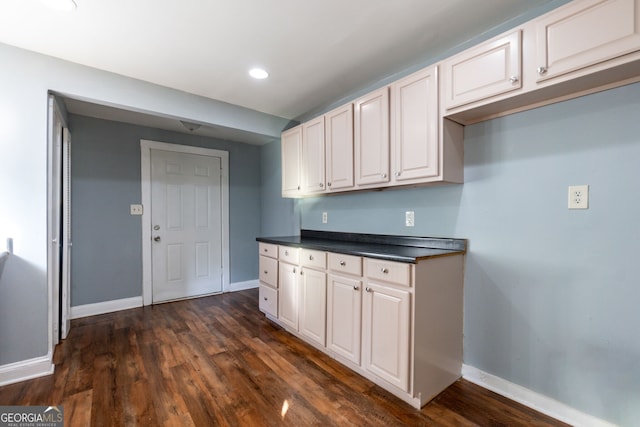 kitchen featuring white cabinetry and dark hardwood / wood-style flooring