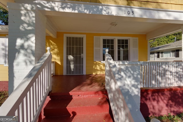 doorway to property with covered porch