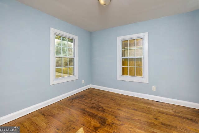 spare room with wood-type flooring