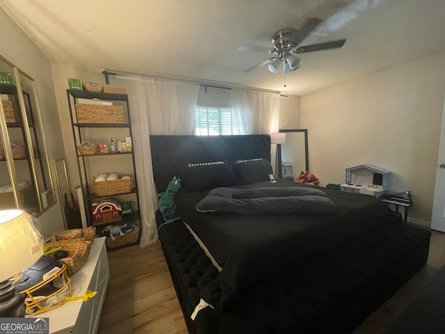 bedroom with wood-type flooring and ceiling fan