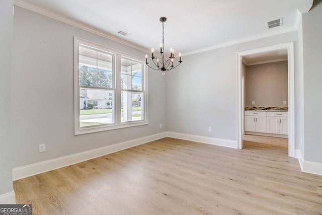 unfurnished dining area featuring crown molding, a chandelier, and light wood-type flooring