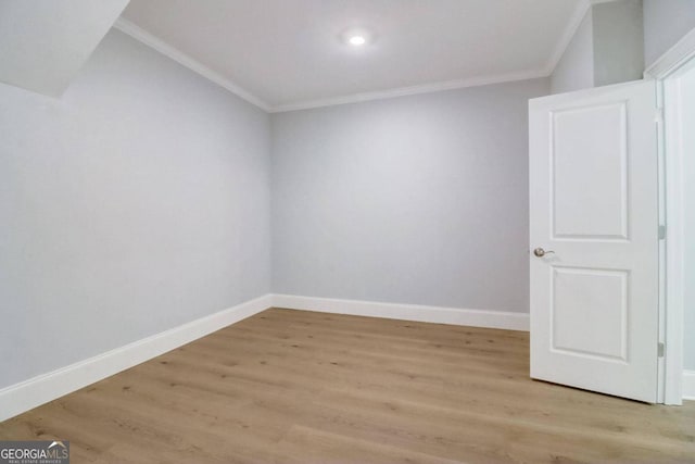 empty room with light hardwood / wood-style flooring and ornamental molding