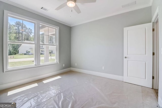 empty room with crown molding and ceiling fan