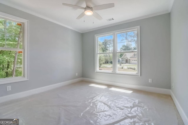 unfurnished room with crown molding, a wealth of natural light, and ceiling fan