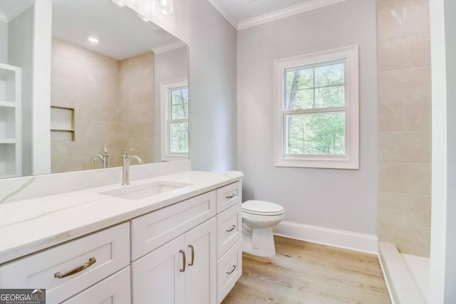 bathroom featuring vanity, hardwood / wood-style floors, ornamental molding, and toilet