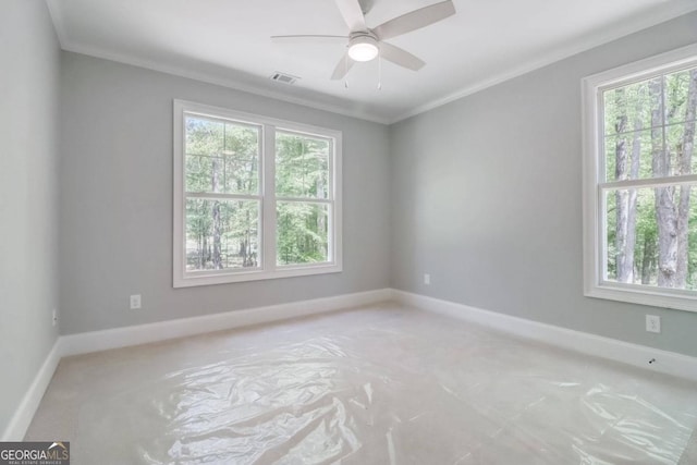 spare room with ceiling fan, ornamental molding, and a healthy amount of sunlight